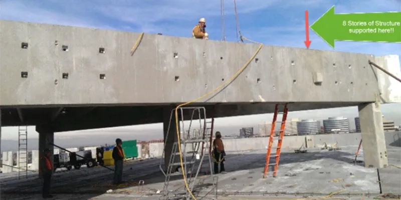 Village Center Station III: Transfer beam over garage. Arrow shows where column sits on beam.