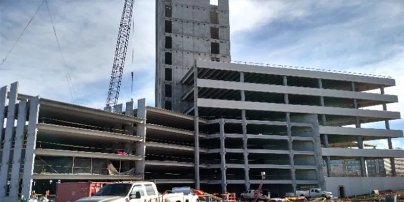 Village Center Station III: Construction well under way. Garage on the left and office tower on right with CIP core in background.